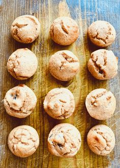 twelve chocolate chip muffins sitting on top of a wooden cutting board