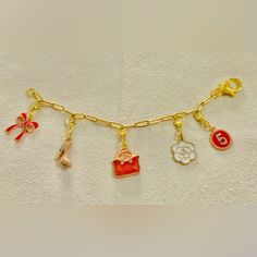 Handmade Paperclip Chain Bracelet With 5 Interchangeable,Detachable Enameled Charms;Paperclip Chain- 7inches;Material-18k Plated Stainless Steel Chain; Charms-Metallic Alloy;This Is Handmade, Expect Imperfections.; Warning: In Order To Extend The Life Of The Charms;Avoid Contact With Perfume, Water, Body Oils And Other Chemicals, Including Household Cleaners. It Should Be Cleaned Gently And Wiped With A Soft Cloth To Remove The Sweat And Dust Remaining On The Charms. Charm Link Bracelet As A Gift, Elegant Gold Charms With Chain, Yellow Gold Bracelets With Logo Charm For Gifts, Yellow Gold Bracelets With Logo Charm As Gift, Enamel Charms Bracelets For Gift, Gold-tone Chain Bracelet With Logo Charm As Gift, Gold Enamel Charms With Removable Details, Elegant Metal Charms With Chain Detail, Elegant Metal Charms With Chain