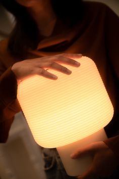 a woman holding a lit up light in her hands