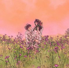 two people are standing in a field with purple flowers and one is holding the other's head