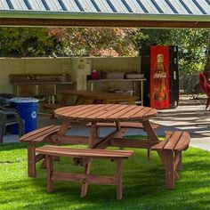 a picnic table and benches in the grass