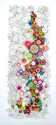 an art piece made out of buttons on a white wall