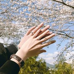 a woman's hand reaching up into the sky