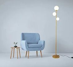 a blue chair sitting next to a floor lamp