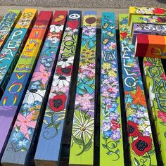 colorful painted wooden benches sitting on the side of a road