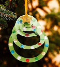 an ornament hanging from a christmas tree on a tweep that is decorated with circles and dots