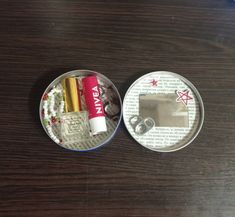 two tins with different items on them sitting on a table