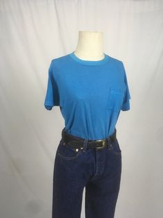 "vintage 1980s pocket t-shirt Fruit of The Loom 100% cotton blue made in USA crew neck single stitch good vintage condition, light wear-worn thin, faded,  sleeves and neck colors slightly different uneven hem marks on front above hem-see photos previous owner's name marked on inner neck labeled large, more like s/m-see below measures, lying flat shoulder-16 1/4\" chest-19\" sleeve-6 1/2\" length-27 1/2\"" Unique Fruit, Pocket Tshirt, Blue Tshirt, Pocket Tee, The Loom, Fruit Of The Loom, Made In Usa, Gender Neutral, Bathing Beauties