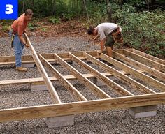 two men are working on building a house