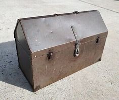 an old metal box sitting on the ground