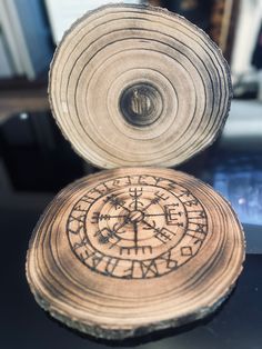 a piece of wood that has been carved into the shape of a compass on it