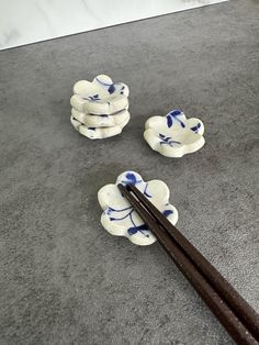 chopsticks and bowls sitting on the floor next to each other