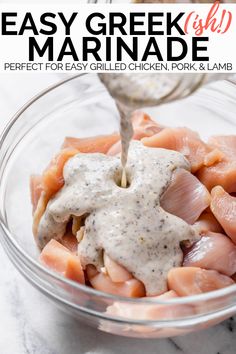 a glass bowl filled with meat and dressing being drizzled over the top