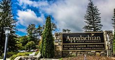 the sign for appalachan state university in front of some trees and bushes