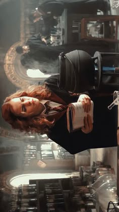 a woman with red hair is standing in front of a clock