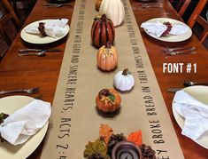 the table is set for thanksgiving dinner with place settings and napkins on each side