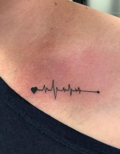 a woman's chest with a heartbeat tattoo on the left side of her neck