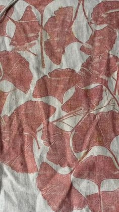 a red and white fabric with leaves on it