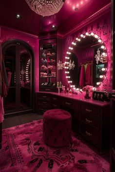 a bedroom with pink lighting and a vanity