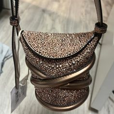 Authentic Alexander Mcqueen Metallic Calfskin Crystal Mini Curve Bucket In Bag Rose Gold This Chic Crossbody Features A Crystalized Exterior In Rose Gold, A Crisscross Strap Accent, And An Adjustable Shoulder Strap. The Flap Top Opens To A Leather Burgundy Base Length:3.25 In Height:4.25 In Width:3.00 In Drop:19.50 In Metallic Clutch Bag, Alexander Mcqueen Bag, Metallic Clutch, Rose Gold Color, Criss Cross, Bucket Bag, Alexander Mcqueen, Calf Skin, Gold Color