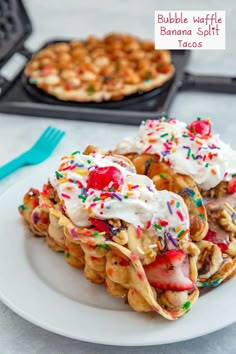 some waffles with whip cream and sprinkles on them sitting on a plate