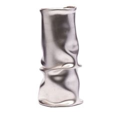 a silver vase sitting on top of a white table