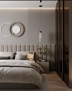 a bedroom with a large bed and a round mirror on the wall above it's headboard