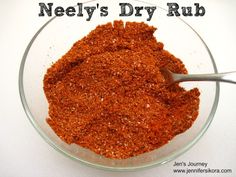 a glass bowl filled with dry rubs on top of a table