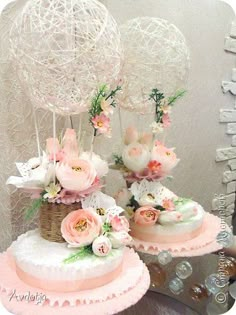 three tiered wedding cakes with flowers on top are displayed in front of a mirror