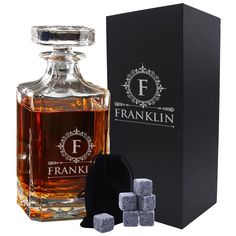 a bottle of frankkin whiskey next to some ice cubes and a black box