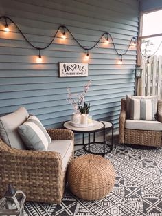 two wicker chairs sitting on top of a rug next to a table and chair