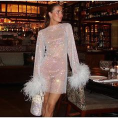 Material : Synthetic Fiber , Feather , Sequin Model is wearing a size small. Jennifer Dress, Night Club Dresses, Rhinestone Fabric, Fabric Feathers, Long Sleeve Mesh Dress, Party Kleidung, Tassels Fashion, Long Sleeve Knit Dress, Feather Dress