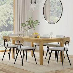 a dining room table with four chairs and a round mirror