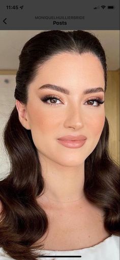 a woman with long hair and brown eyes is looking at the camera while wearing makeup