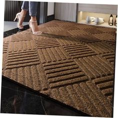 a woman standing on top of a brown rug