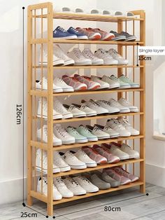 a wooden shoe rack filled with lots of shoes