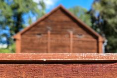 Close up of a red wooden wall with building behind it stock photography Triangle Architecture, Wooden Wall, Wooden Walls, Close Up, Photo Image, Stock Photos, Architecture