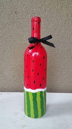 a watermelon painted wine bottle with a black bow