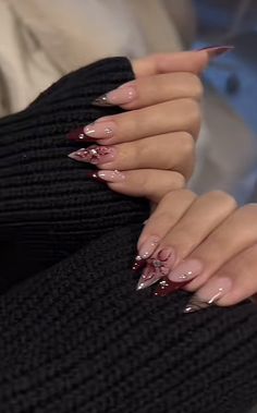 a woman's hands with long, shiny nails