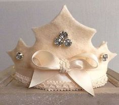 a white crown with bows and jewels on it