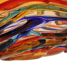 a multicolored glass bowl sitting on top of a table