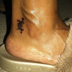 a foot with a small tattoo on it