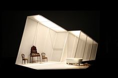 an empty stage with chairs and tables in it