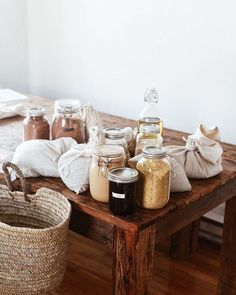 some jars are sitting on a wooden table