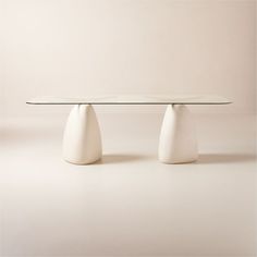 two white vases sitting on top of a table