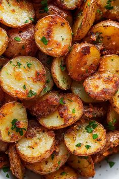 cooked potatoes with parsley in a white bowl