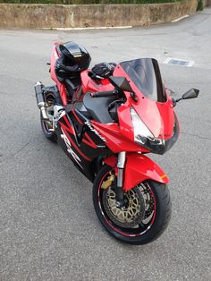 a red and black motorcycle parked on the street