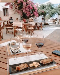 two glasses of wine and some food on a table