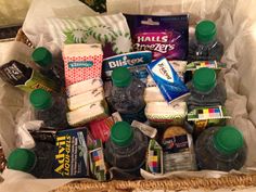 a basket filled with bottled water and snacks