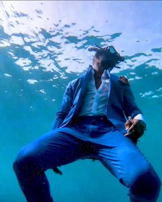 a man in blue suit and hat under water